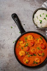 Shrimp in curry coconut sauce with rice in a bowl - Curried prawns,  overhead view