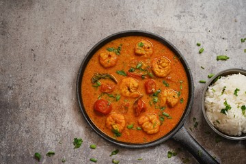 Shrimp in curry coconut sauce with rice in a bowl, overhead view - obrazy, fototapety, plakaty