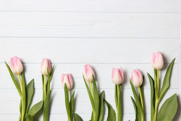 A bouquet of tulips on a wooden background top view. Spring background. Background to Mother's Day, International Women's Day, birthday.