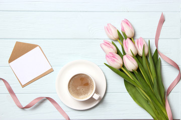 bouquet of beautiful tulips, gift and coffee on wooden background top view. Mother's Day Background, International Women's Day, Birthday. Holiday, give a gift.