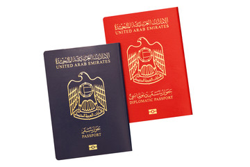 Blue and red biometric passports of United Arab Emirates isolated on white background