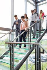 business people walking down stairs.