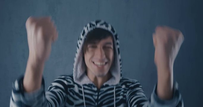 Portrait of Amazed Surprised Young Man in costume zebras on gray background. Emotions of joy and delight