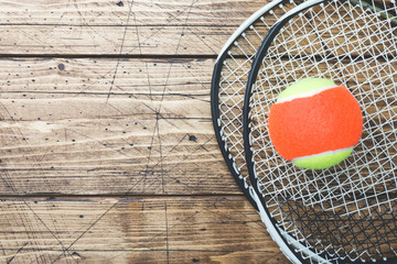 Tennis Ball and rackets on Wood Background, Sport Concept and Idea, Rustic Style. © Elenglush