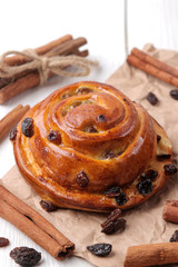 Tasty buns with raisins and cinnamon on a white wooden background. fresh bakery. breakfast.