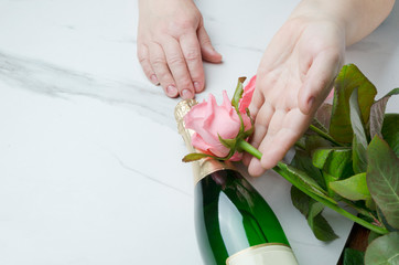 St. Valentine's Day concept.Woman getting present for Valentine`s Day bouquet of roses.Champagne for romantic dinner