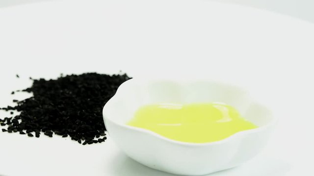 black cumin seeds with black cumin oil on a turn table