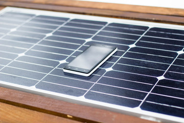 mobile phone on a solar panel outdoor close up