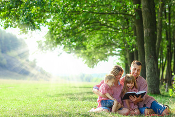 young family reading the Bible