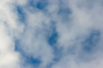 Morning sunrise. Blue sky with clouds. The morning sun illuminates the clouds.