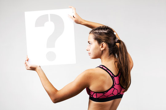 fit girl holding question mark