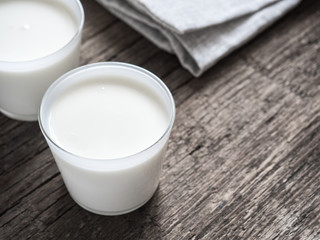 Healthy breakfast. Yogurt in white glasses on wooden background. Copy space