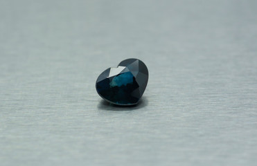 Blue gemstone carved in the shape of a heart