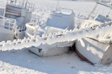 Icy old frozen ships in the port of Olkhon island on siberian lake Baikal at winter time, the Village of Khuzhir, Russia.