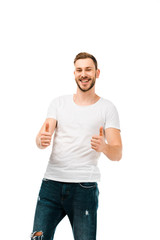 handsome happy young man showing thumbs up and smiling at camera isolated on white