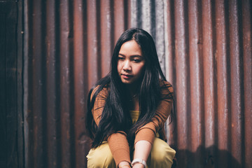 Outdoor portrait of a sad asian girl