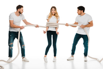 young men holding rope wrapped around smiling young woman showing thumbs up and looking at camera...