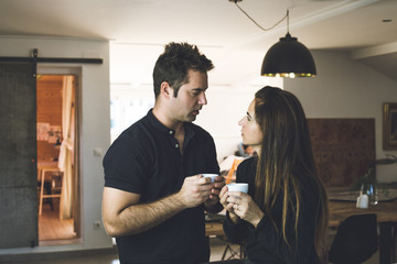 Portrait of a couple drinking happy coffee and smiling at home