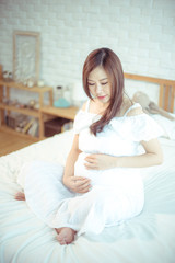 Obraz na płótnie Canvas Attractive pregnant asian woman