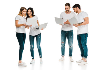 Fototapeta premium smiling young men and women standing together and using laptops isolated on white