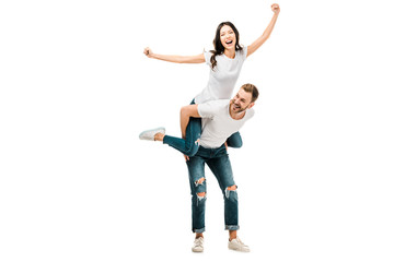 cheerful young couple piggybacking and having fun together isolated on white