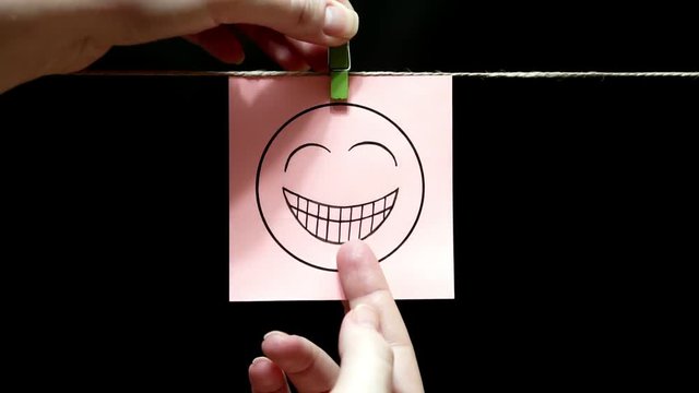 On the white sticker an expression of festive mood. The sheet is attached manually with a clothespin on the rope.