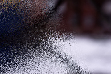 Water drops on glass window close up with blurred background. Drops in macro. Condensate on window...