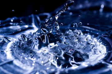 Water drops splashing on acoustic membrane. A lot of drops in air. High frequency of sound waves....