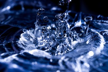 Water drops splashing on acoustic membrane. A lot of drops in air. High frequency of sound waves....