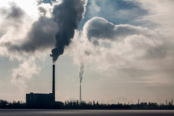 Smoky industrial pipe in the background. Environmental pollution. Ecology problems. Environmental...