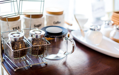 coffee bean and tea with sugar in a glass jar on wooden table