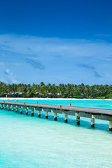 tropical Maldives island with white sandy beach and sea
