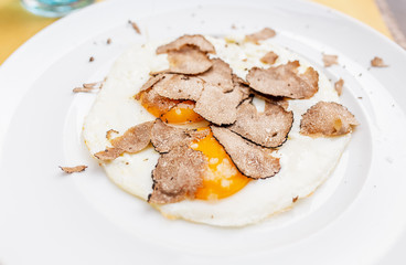 Fried eggs with truffle chips on a plate, italian cuisine and fine dining concept