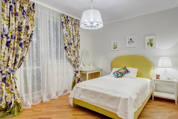 Interior of stylish and sweet bedroom for girl in green, white colors and big window, curtain in...