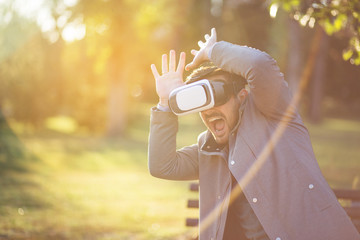 Portrait of young bearded businessman using Vr glasses