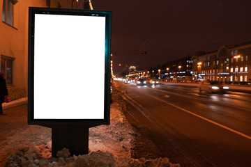 vertical poster. outdoor advertising in the evening. stand for advertising mockup