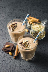 Chocolate almond milk oat smoothie on dark background. Selective focus, space for text.