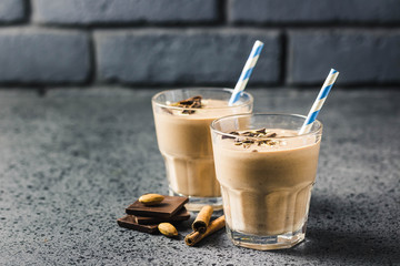 Chocolate almond milk oat smoothie on dark background. Selective focus, space for text.