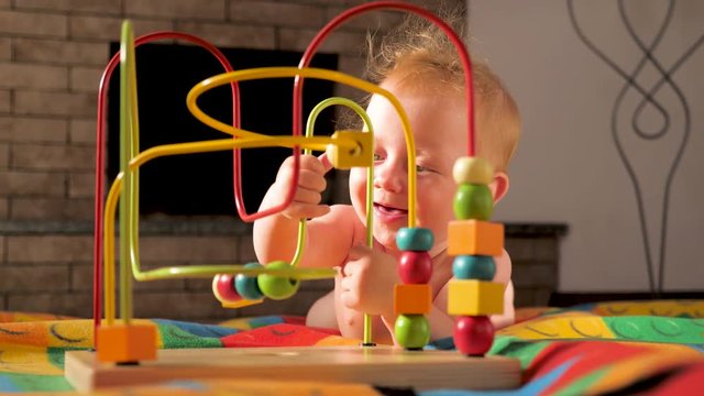 Colorful toy appealing to hold. Montessori background. Toddler developing fine motor skills. Supporting the development of fine motor skills. Fine motor skills developing. Gifts for toddlers, babies.