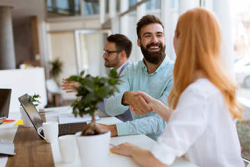 Business people shaking hands in office
