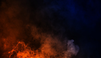 Abstract blue vs orange smoke steam moves on a black background . The concept of aromatherapy