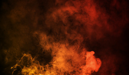 Abstract orange vs red smoke steam moves on a black background . The concept of aromatherapy