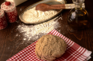 Food baking background. Ingredient of homemade baking on wooden table. Wheat, sugar, salt, oil, spoon, red cloth.
