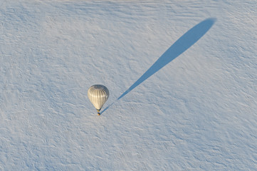 white hot air balloon on the snow field