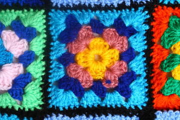 Multicolored handmade plaid of crochet made of granny squares - obrazy, fototapety, plakaty