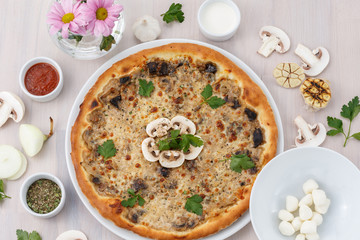 mushroom pizza on wooden background top view