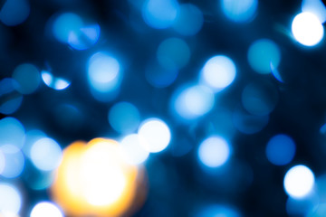 Abstract blurred blue circles on dark background.