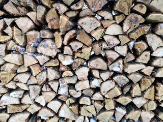 Firewood in winter. The texture of impaled wood in the snow