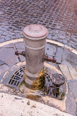 Street drinking water fountain in Rome, Italy, selectifocus