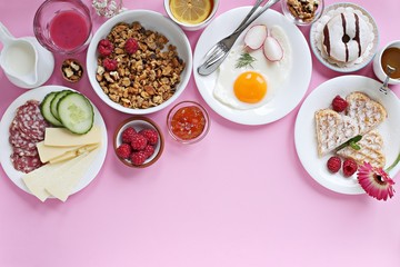 Brunch. Festive family breakfast set for Valentines day, Mothers day or Easter. Pink background. Overhead view, copy space